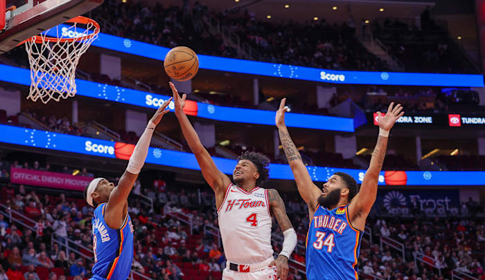 Rockets guard Jalen Green shoots against Oklahoma City Thunder guard Shai Gilgeous-Alexander and forward Kenrich Williams